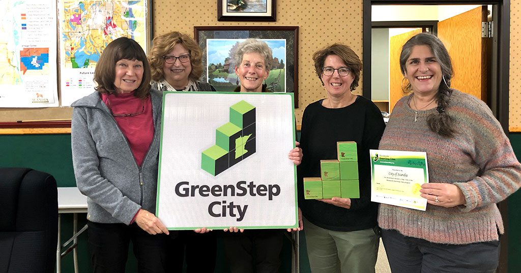 People posing with a GreenStep Cities sign