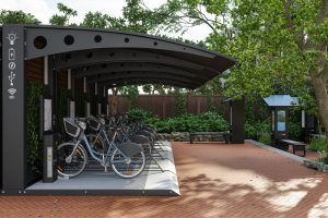 Row Of Bicycles In Parking Station With Solar Panels. Bicycle Sharing System
