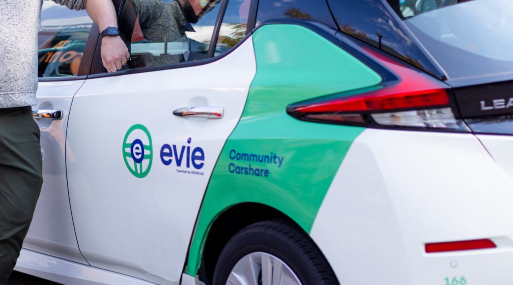 carshare electric vehicle branded with HOURCAR/Evie logo